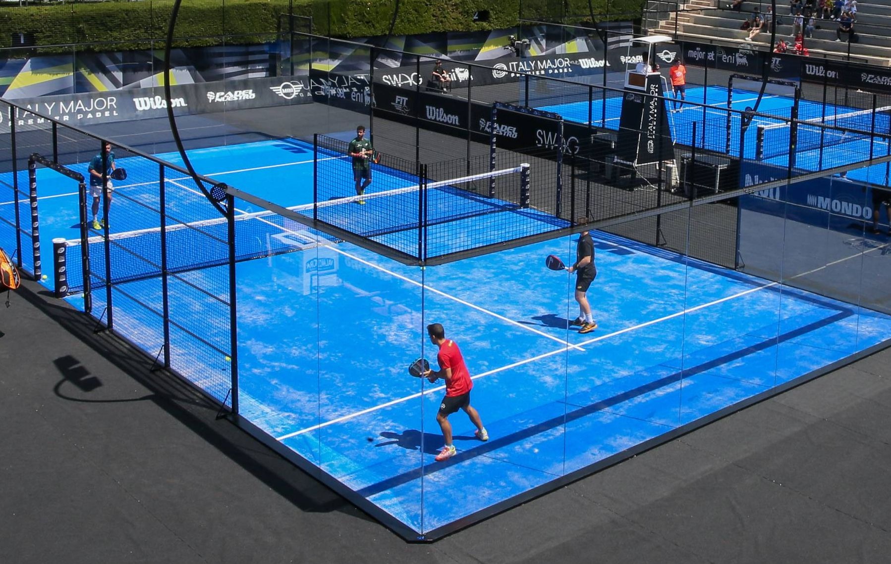 Aerial view of busy padel courts at a tournament venue